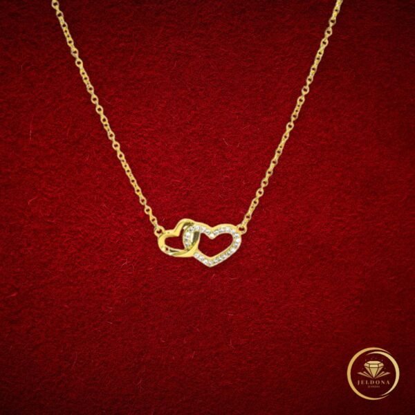Intertwined Hearts Necklace in red cloth background