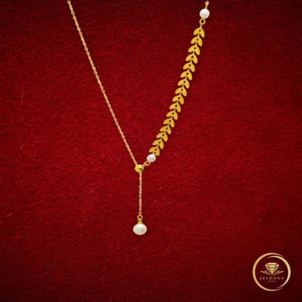 Pearl Whisper Leaf Necklace in red cloth background